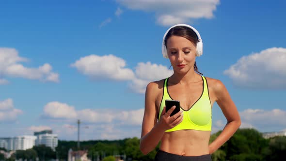 Woman with Headphones and Smartphone Running