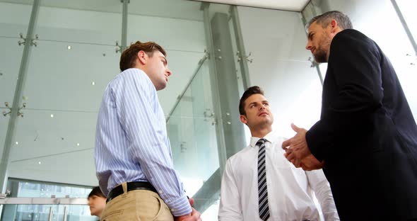 Businessmen shaking hands in office