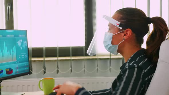 Close Up of Businesswoman Wearing Protection Mask on Desk Office