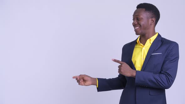 Young Happy African Businessman Pointing Finger and Showing Something