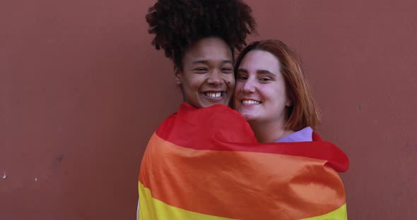 Young lesbian couple smiling on camera outdoor - LGBT pride concept