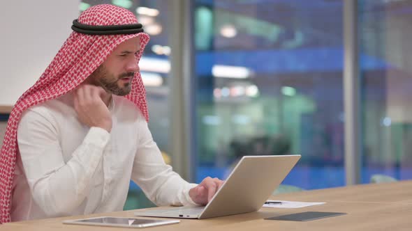 Tired Arab Businessman with Laptop Having Neck Pain