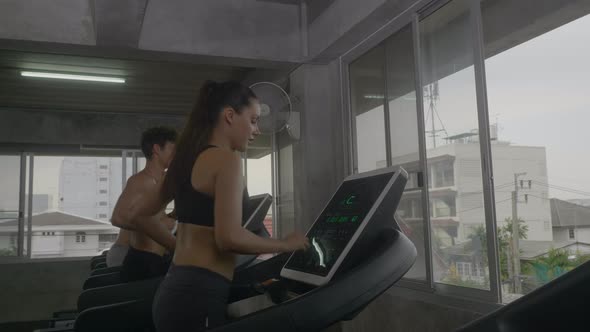 athletic people group running on treadmills, doing fitness exercise, actively workout in the gym