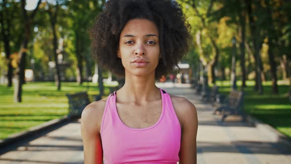 Outdoor Portrait of Young African American Woman Looking Aside and to Camera Tracking Shot