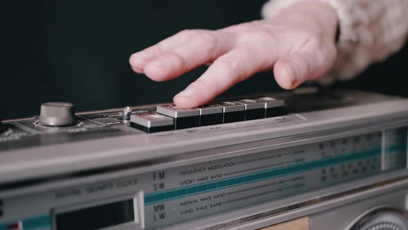 Female Hand Runs Fingers Over the Buttons of an Old Vintage Retro Tape Recorder