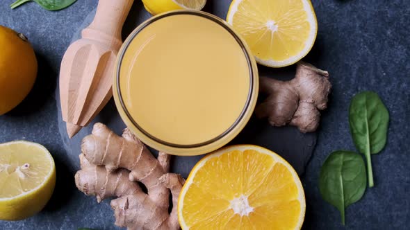 Ginger and orange juice for immunity. Fruit smoothie in glass and ingredients.