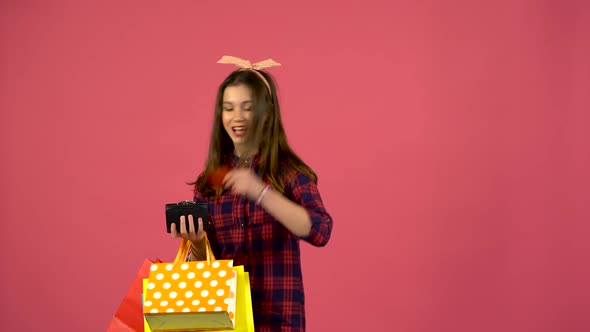 Girl Looks Into Shopping Bags Then the Purse Has Run Out of Money but There Is a Card