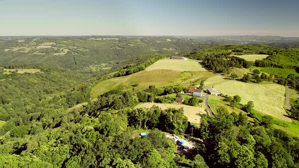 Aerial view of barn and straw bales in field in Correze, France.