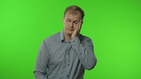 Sleepy Bored Guy Looking at Camera Not Interested in Communication. Man on Chroma Key Background