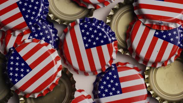 Rotating shot of bottle caps with the American flag printed on them 
