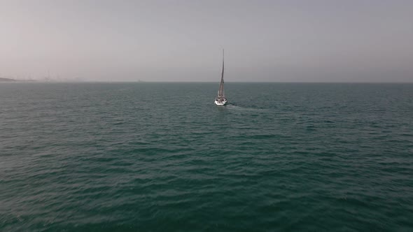 Yacht with Reflection Sailing on Open Sea Aerial