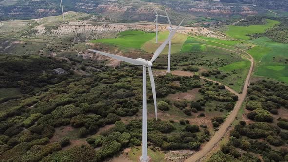 Aerial View of Windmills Farm for Clean Energy Production on Beautiful Cloudy Sky. Wind Power