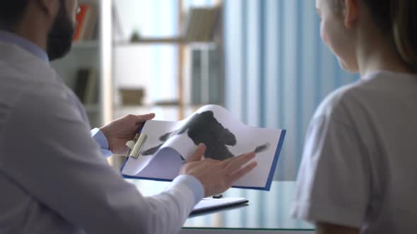 Psychotherapist Showing Rorschach Test Card to Female Patient in Clinic, Health