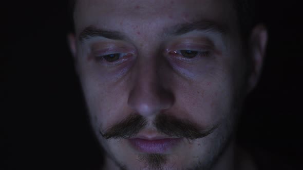 Close up of a man watching on a screen