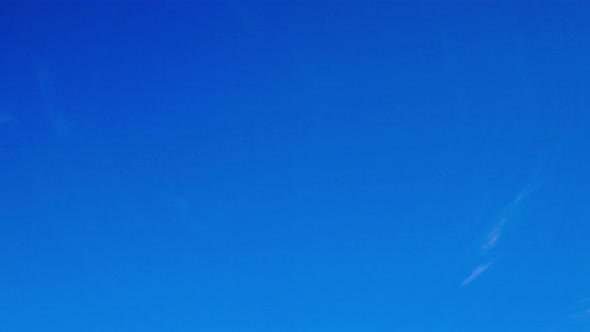 Time lapse of peaceful clouds forming in a vivid blue sky