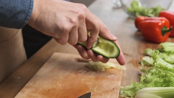 Cooking Salad at Home Man Hands Pulling Out the Pulp From a Cucumber with a Spoon