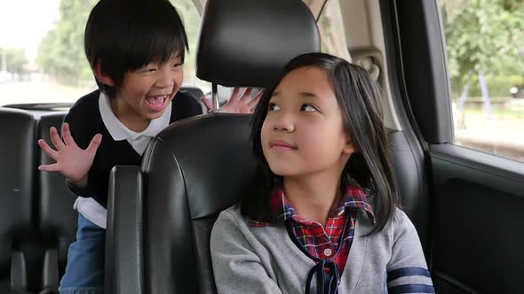 Happy Asian Children Playing Hide And Seek While Travels By Car