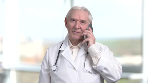 Very Old Senior Physician Talking on Phone