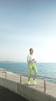 Sportswoman Running on Border Near Sea