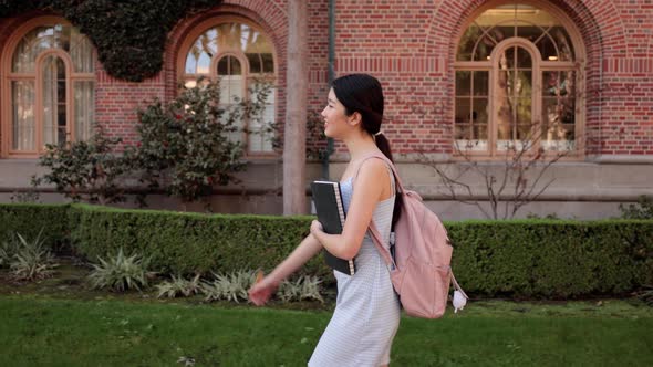Asian female college student walking  to her class