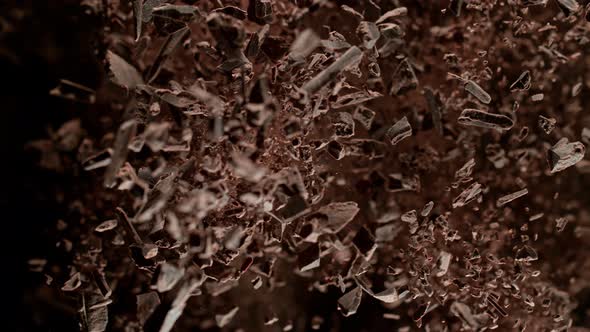 Super Slow Motion Shot of Raw Chocolate Chunks and Cocoa Powder After Being Exploded at 1000Fps