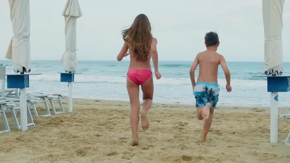 Cheerful Children Having Fun at Sand Beach