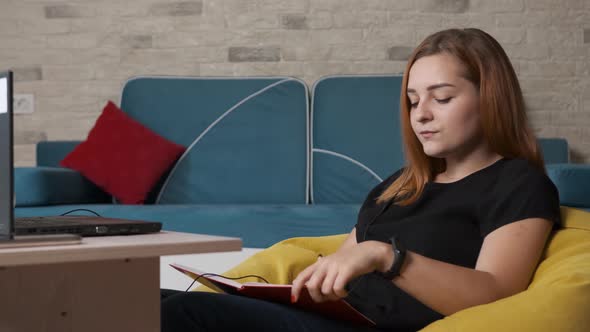 Young Woman Is Working at the Laptop From Home Office.