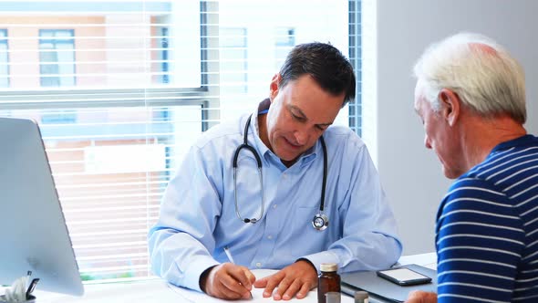 Doctor prescribing medicine to senior patient