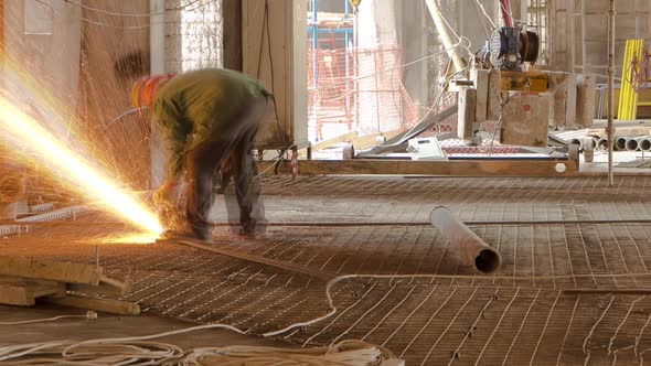 Construction Works with Circular Abrasive Cutoff Saw Angle Grinding Machine and Sparkles Timelapse