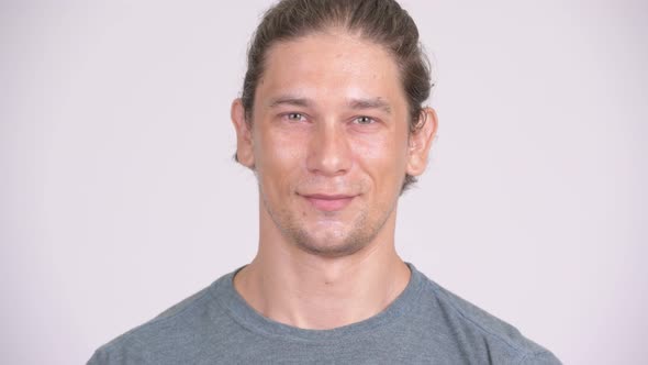 Face of Happy Handsome Man Smiling Against White Background