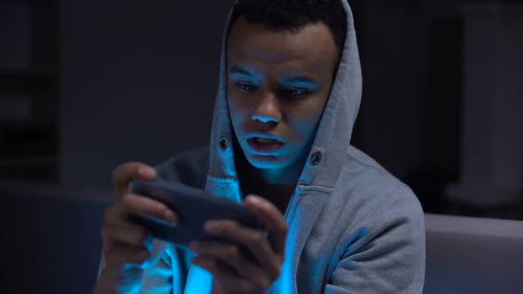Black Teenager Playing Video Games on Phone Harm for Mental Health and Eyesight