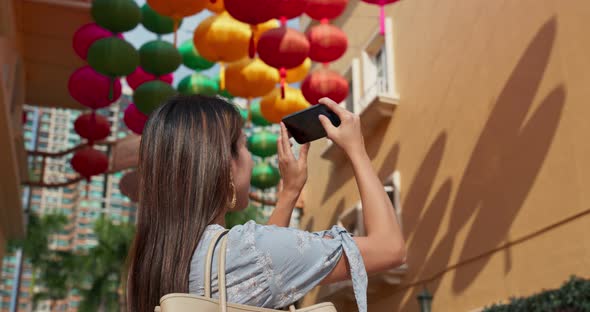 Woman take photo on mobile with chinese lantern at outdoor