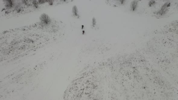 two guys riding motorcycles in the snow