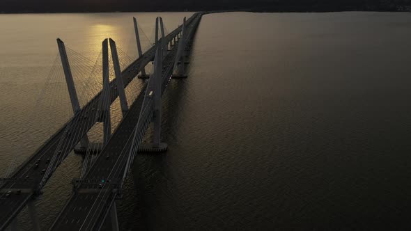 An aerial shot of the Mario M. Cuomo Bridge from the north side. The camera dolly in over the bridge