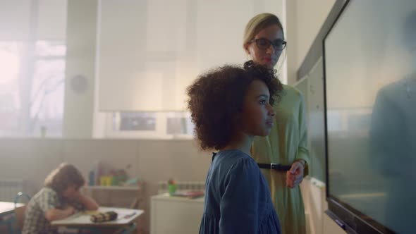 Schoolgirl Writing on Interactive Digital Whiteboard