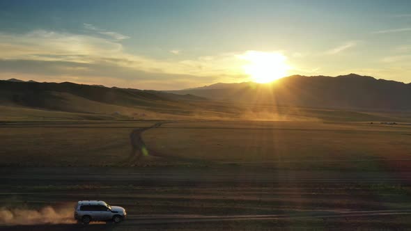 Aerial View of Cars and Yurts in Mongolia Sunset