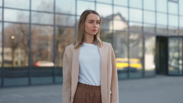 Woman Standing with Crossed Arms Near Office Building