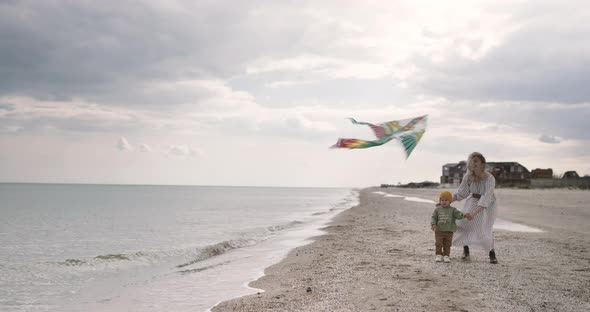 Mom and son together launch kite. Parent spend time with a child. alt