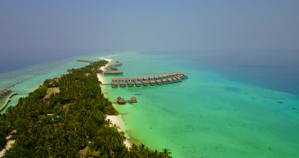 Daytime above abstract view of a sandy white paradise beach and aqua turquoise water background in b