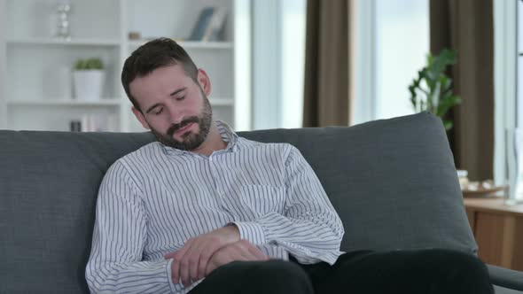 Young Businessman Having Nightmare on Sofa at Home 
