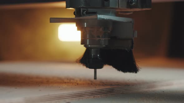 Close Up a Drill of Lathe Makes Holes in a Wooden Slab