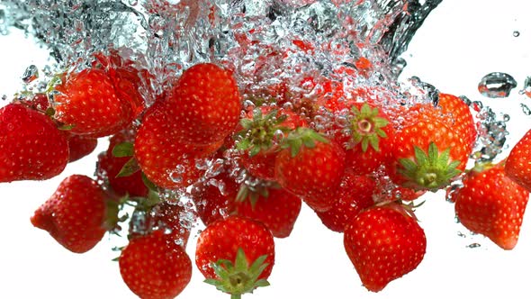 Super Slow Motion Shot of Falling Strawberries Into Water at 1000Fps