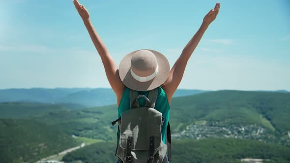 Tourist Woman Raising Hand Standing on Top of Mountain