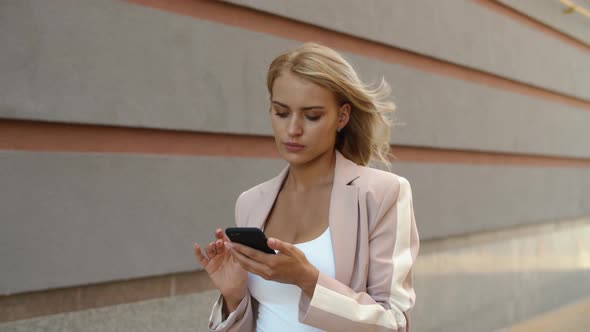 Closeup Businesswoman Using Phone at Street. Woman Messaging on Phone at Street