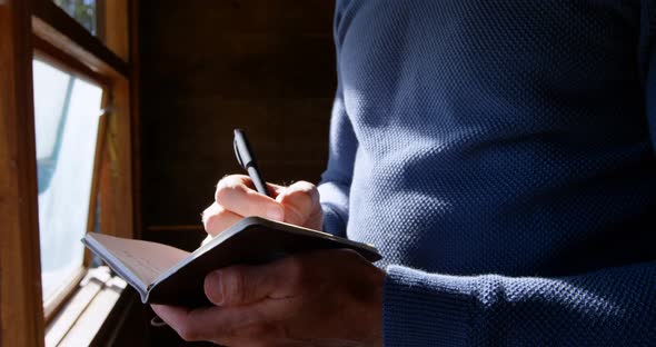 Man Writing on A Diary at Home 4k