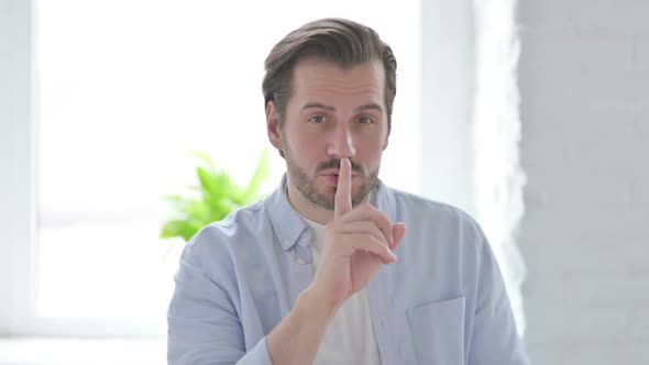 Man Putting Fingers on Lips Quiet Sign