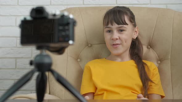 Child Sits By Camera Indoor