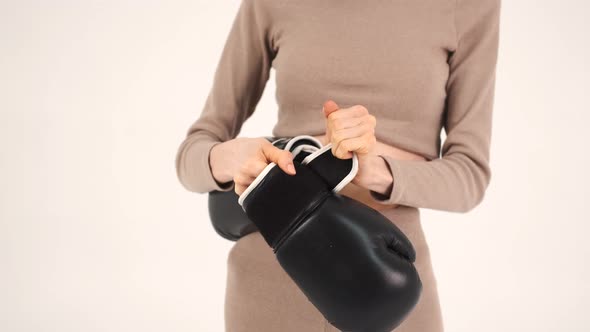 Woman in Sportswear Putting on the Black Gloves and Preparing for Training