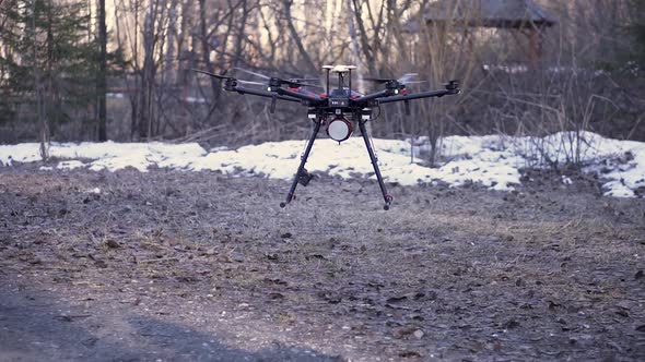 Small black drone with spinning blades