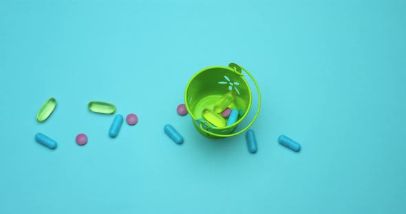 Stop Motion Animation Health Concept, Pills In Motion Animation On Blue Background, Top View. alt